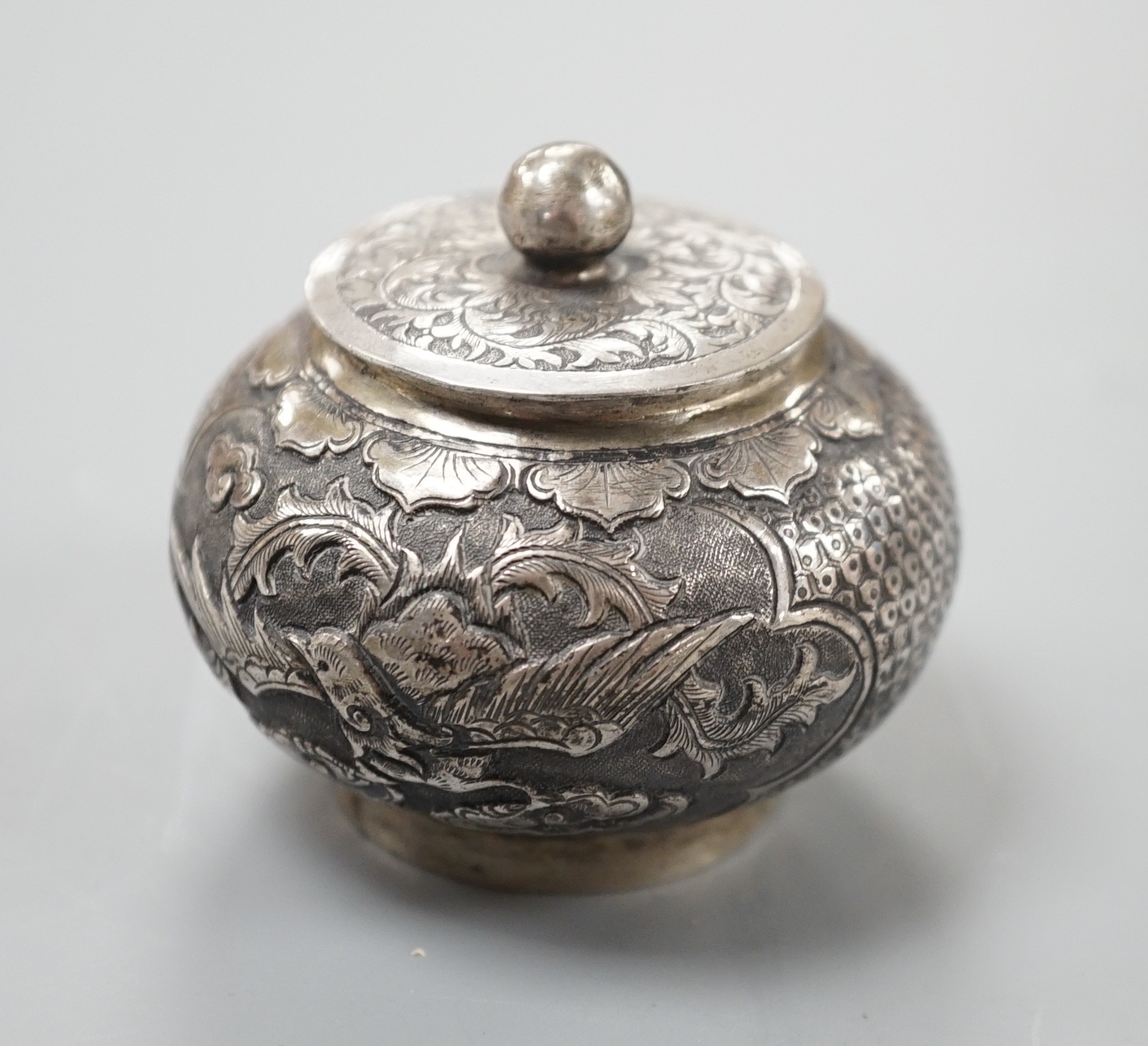 A Chinese white metal unsigned pot and cover, 5cms high.